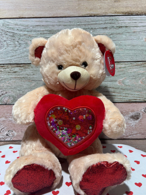 Peluche osito con corazón multicolor.